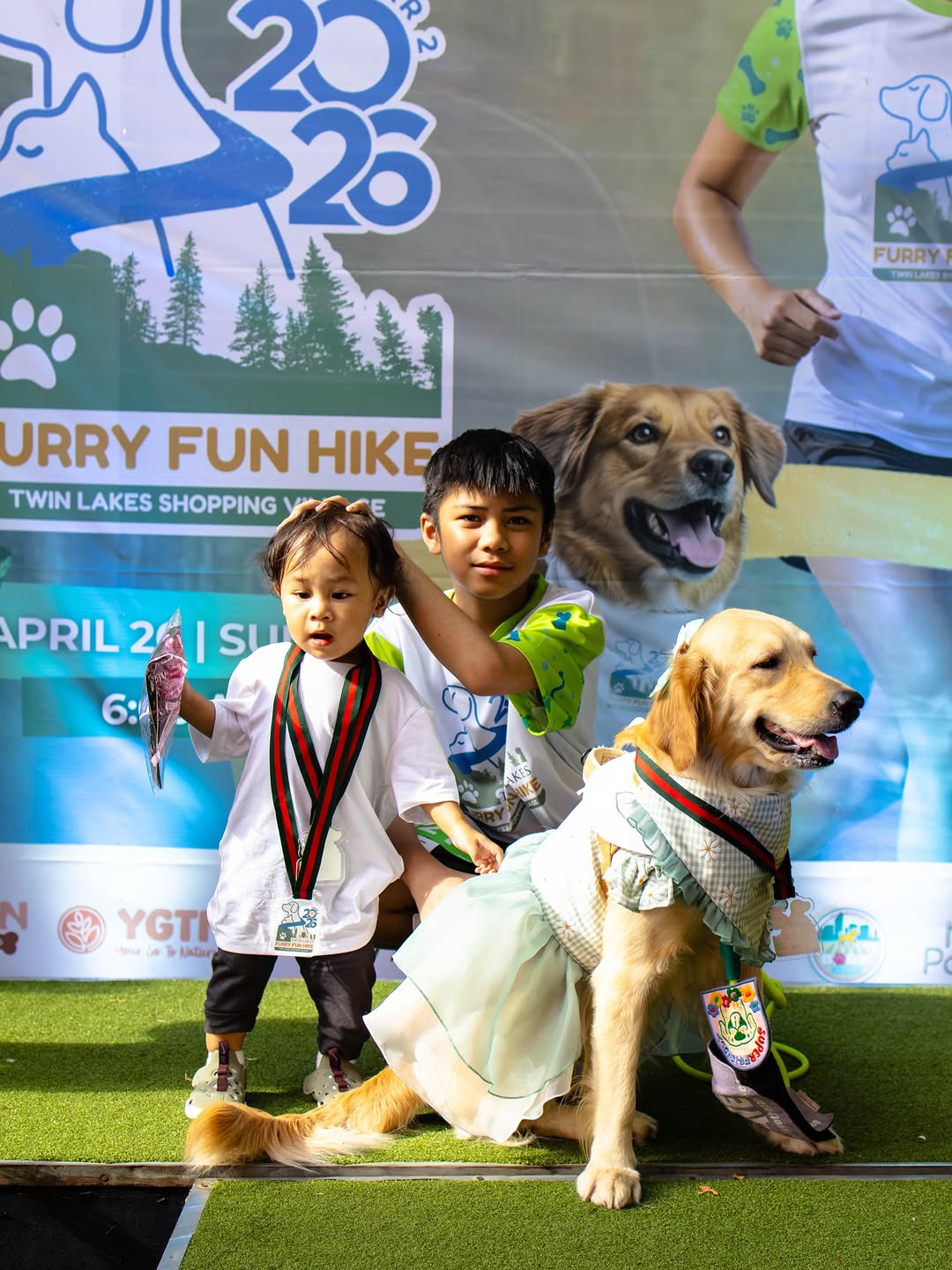 Smiling fur-parents and their pets at the hike